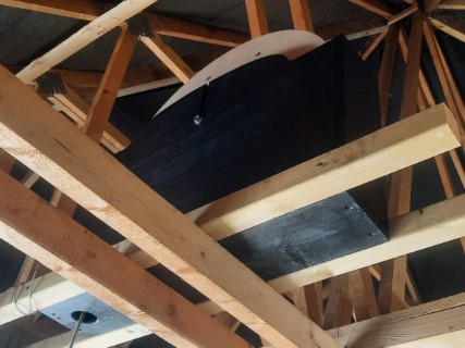 View from below of customised Home Dumbbell installed in the open loft rafters of a large garage, showing extra timber work. 2 of 3